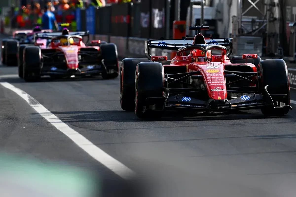 Two Ferrari cars racing on a track