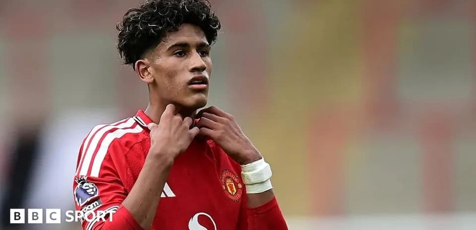 Young player adjusting his collar on the pitch