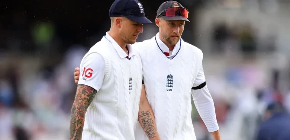 Two England cricket players walking off the field