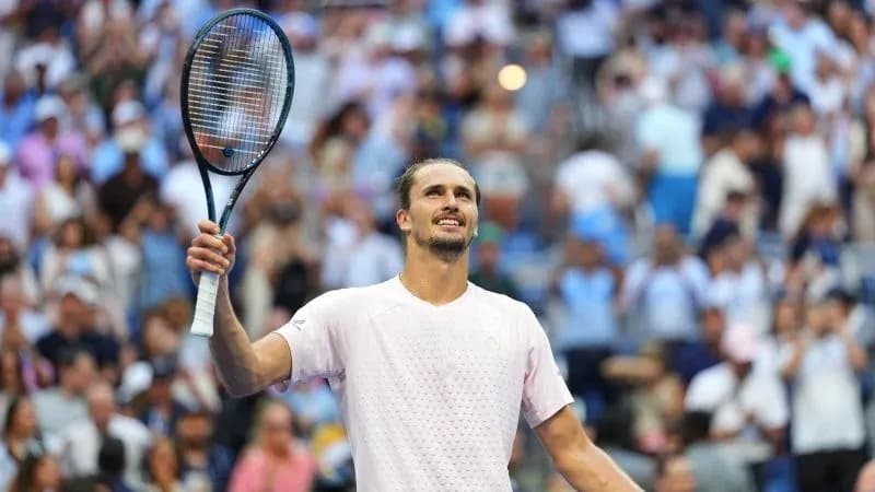 Player celebrating with racket raised in crowd