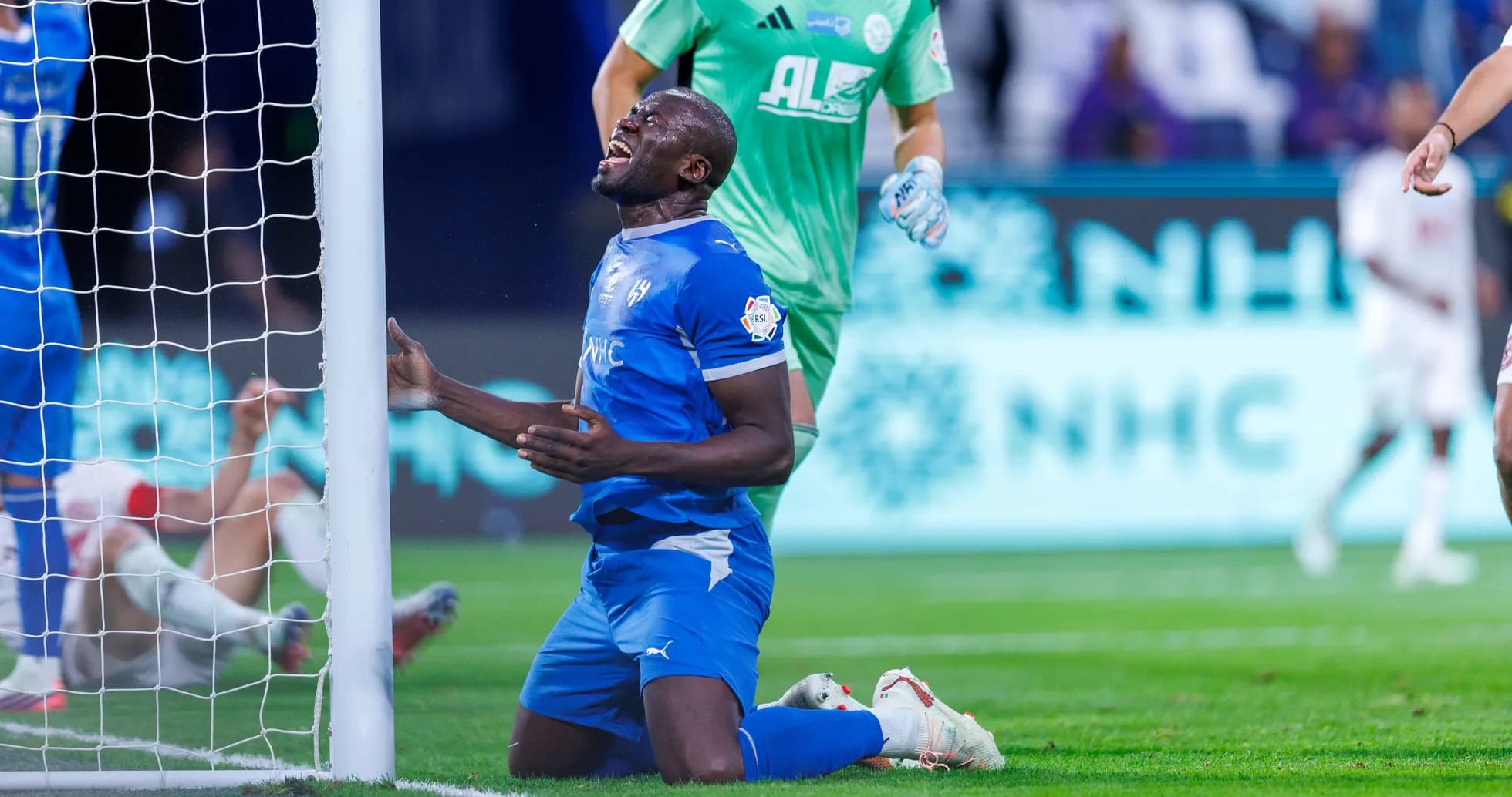 Player on knees near goal after missed opportunity