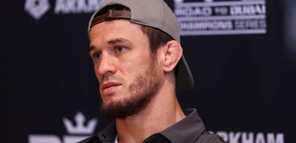 Fighter at press conference with cap and serious expression