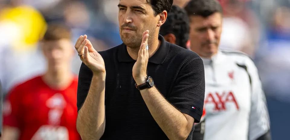 Coach applauding during a match on the sidelines