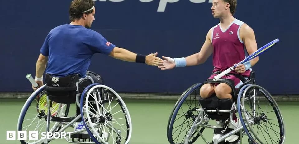 Two wheelchair tennis players shaking hands on court