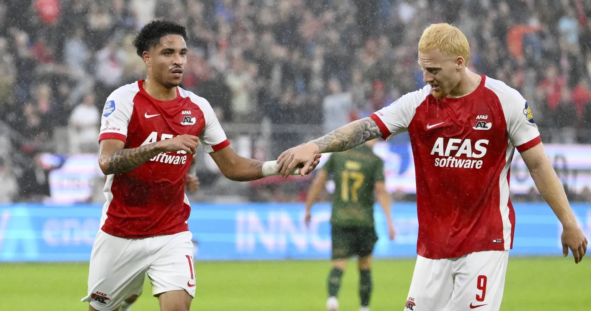 Two AZ Alkmaar players celebrating a goal together