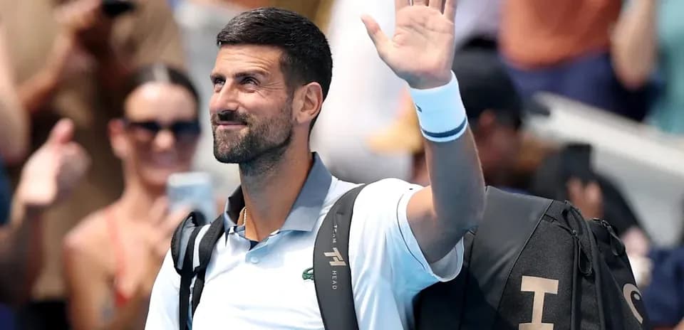 Tennis player waving to crowd after match