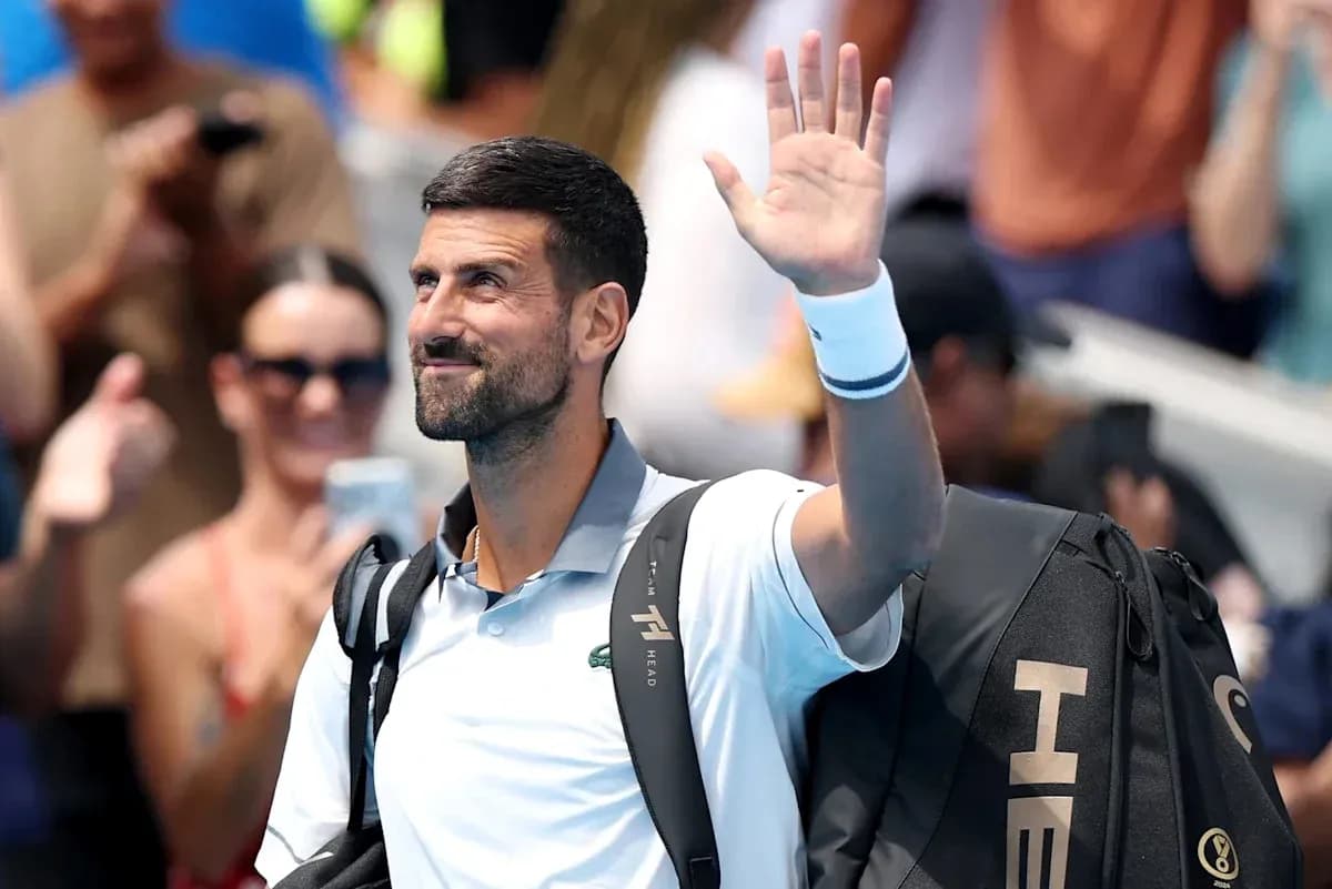 Tennis player waving to crowd after match