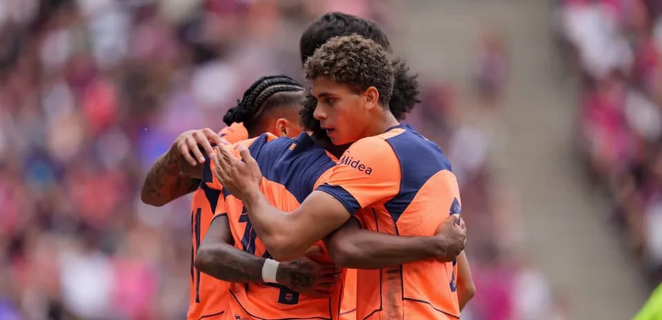 Players celebrating a goal during a match