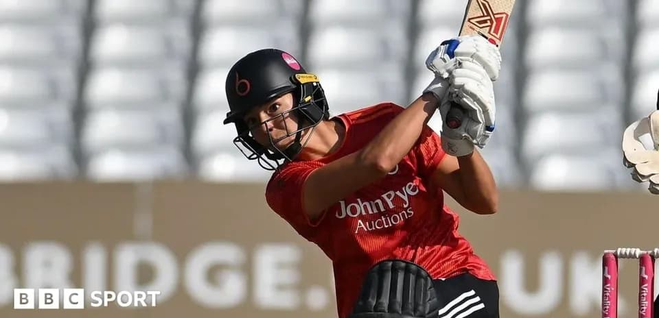 Batter playing a shot during cricket match