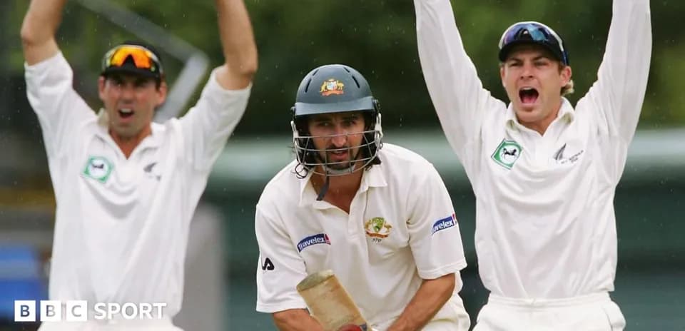 Cricketers celebrating a wicket during a match