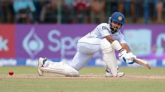 Batsman playing a defensive shot on the pitch