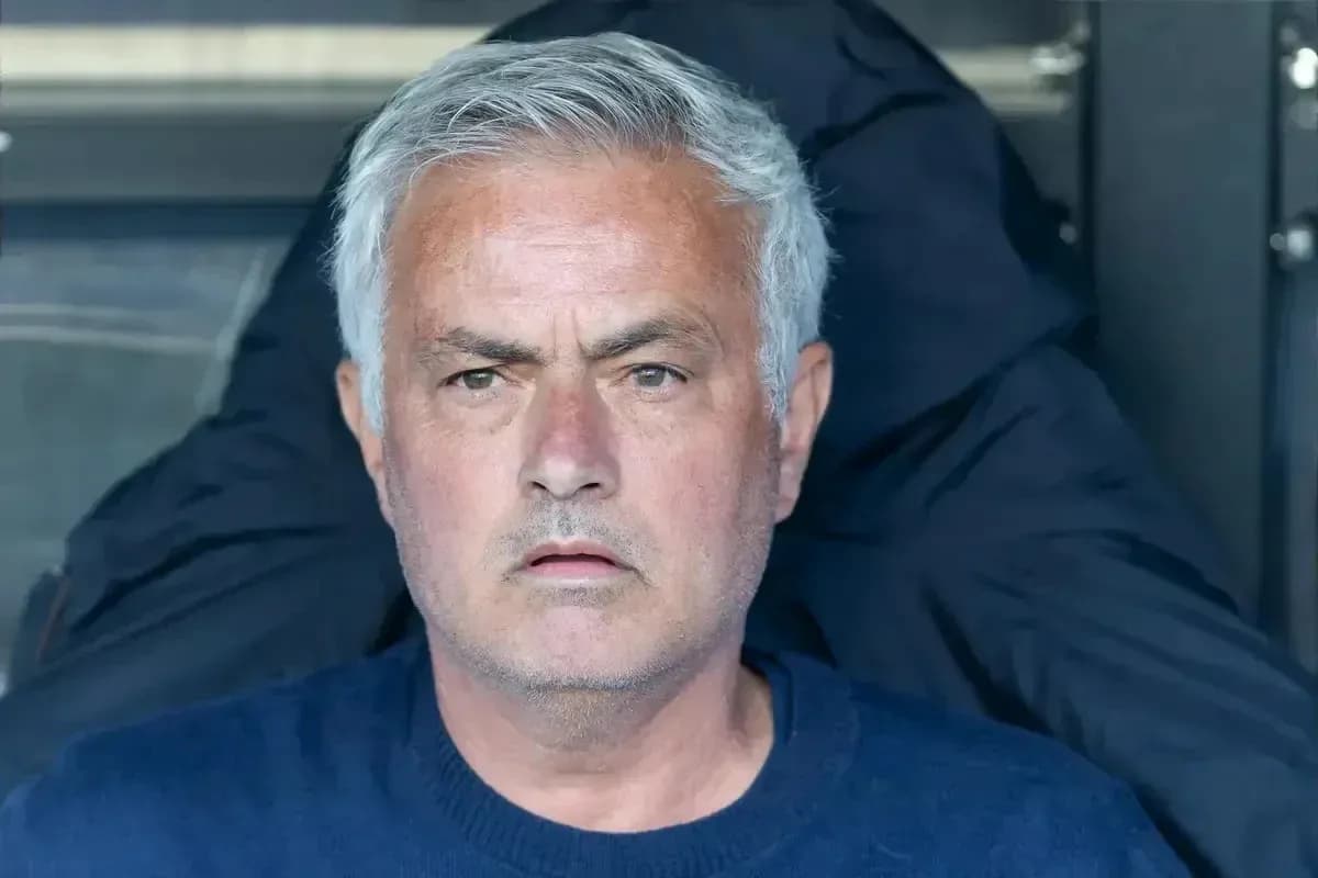Manager seated, focused during a match