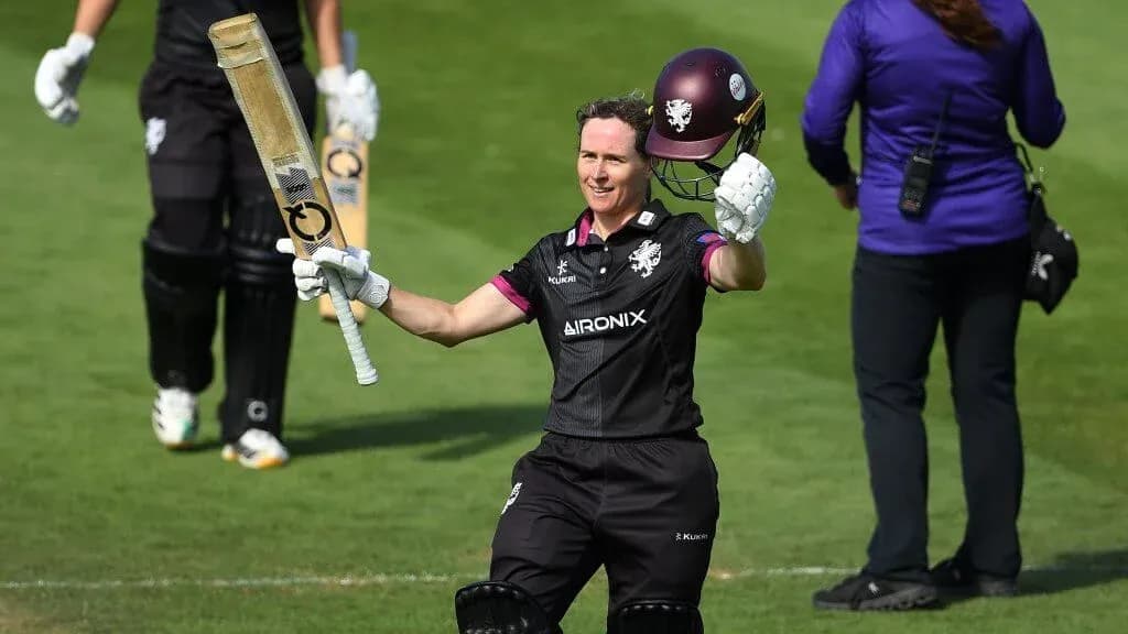 Batter celebrating after scoring a century on field