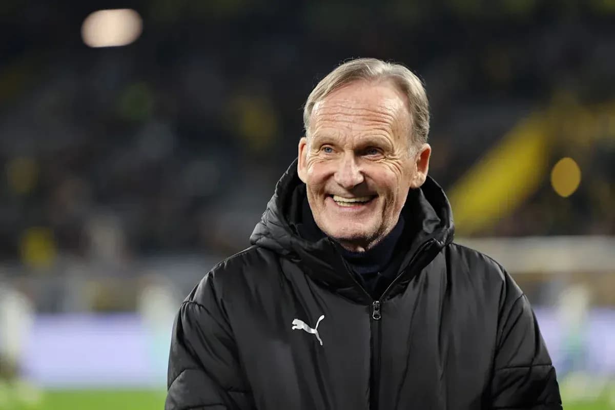 Man smiling on the sidelines during a match