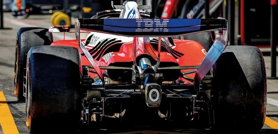 Rear view of a red Formula 1 car in pit lane
