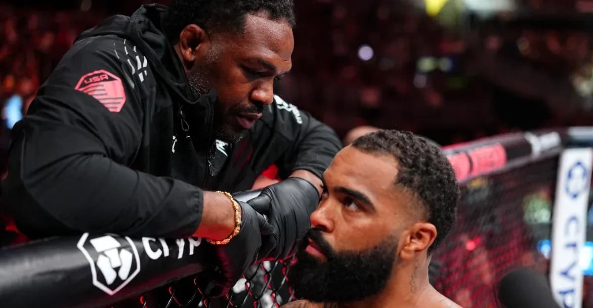 Coach advising fighter during MMA match preparation