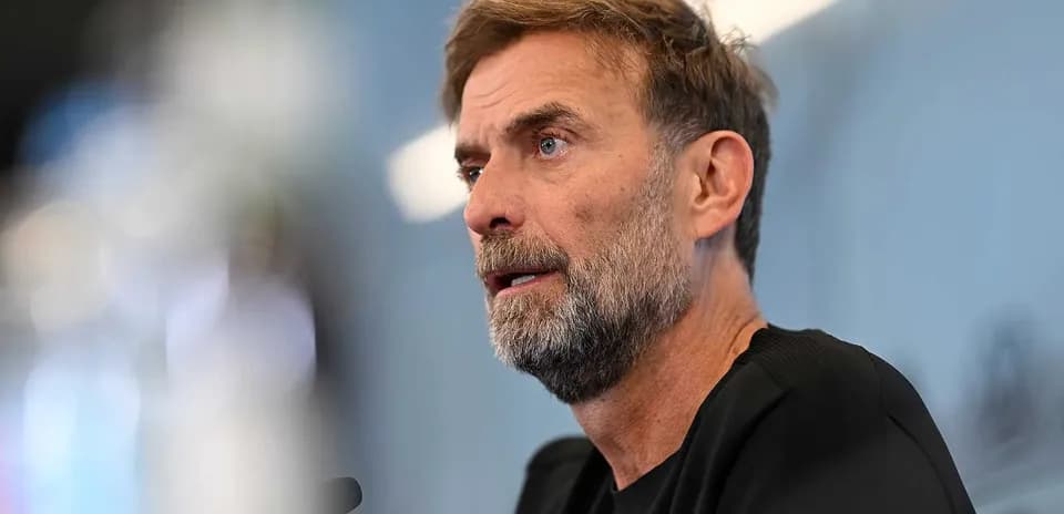 Manager speaking at press conference with microphone