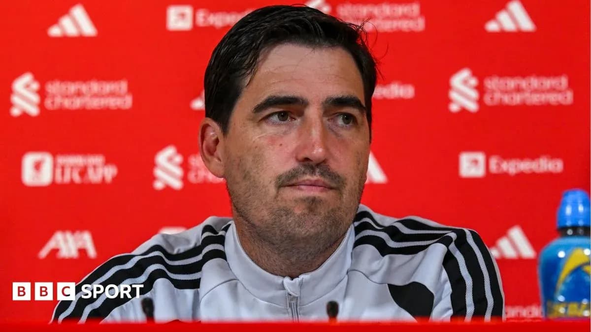 Manager at press conference with sponsor backdrop