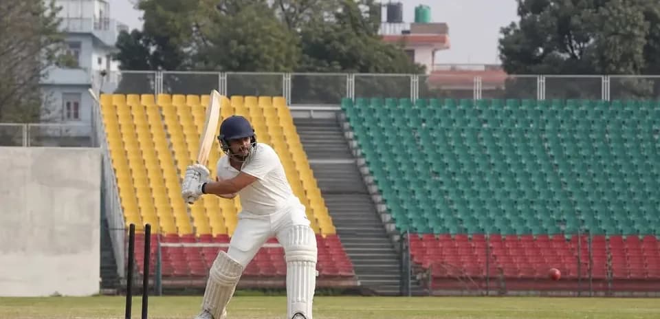 Batter preparing to hit ball on cricket field