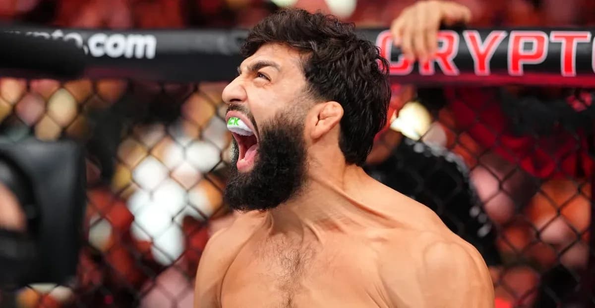 Fighter celebrating with mouthguard in UFC octagon