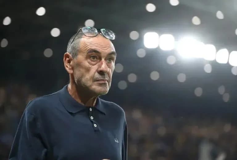 Coach observing match with glasses on his head