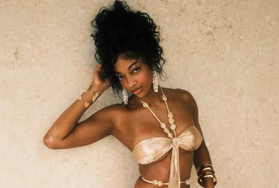 Model posing against a textured beige background