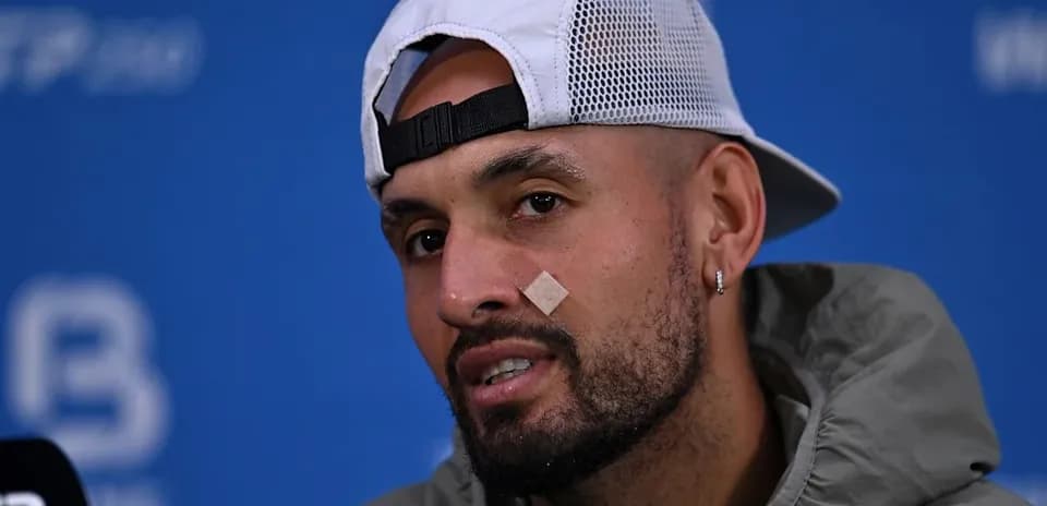Player at press conference with bandage on face