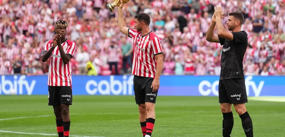 Players celebrating with a trophy in stadium