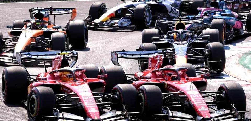 Formula 1 cars racing closely during a competition