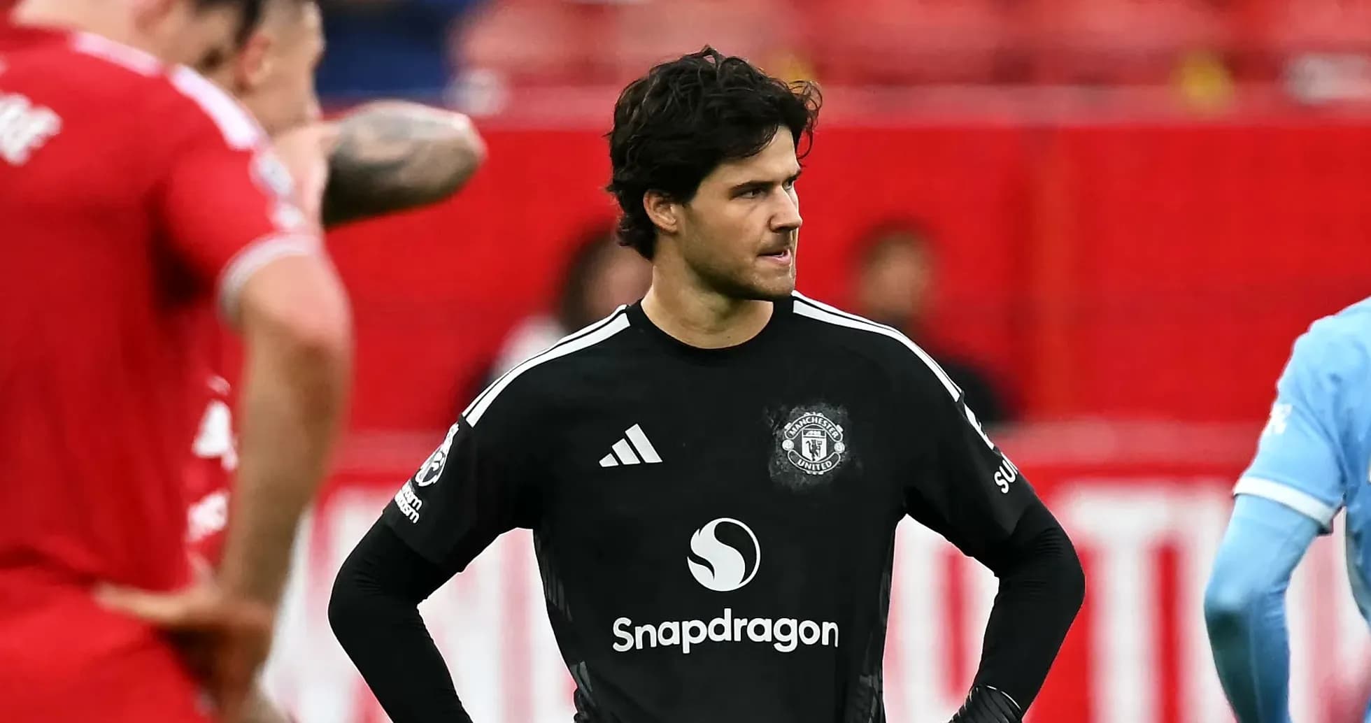 Goalkeeper in black kit during match with teammates