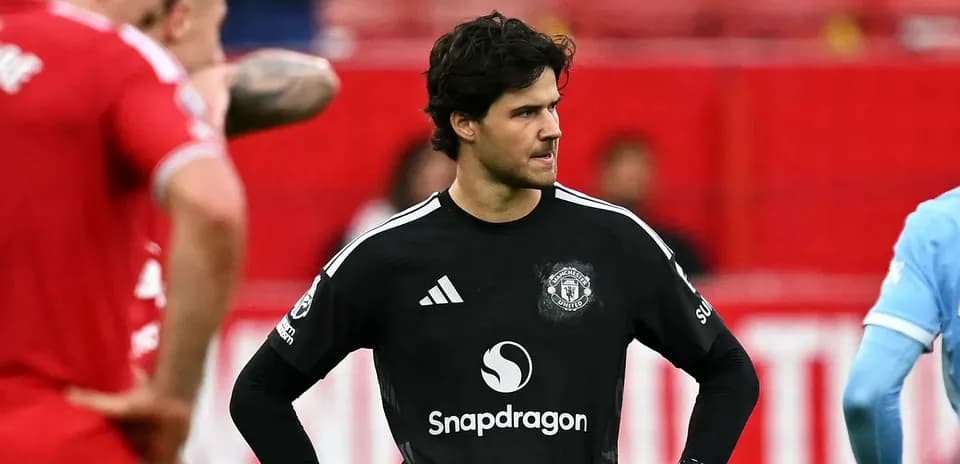 Goalkeeper in black kit during match with teammates