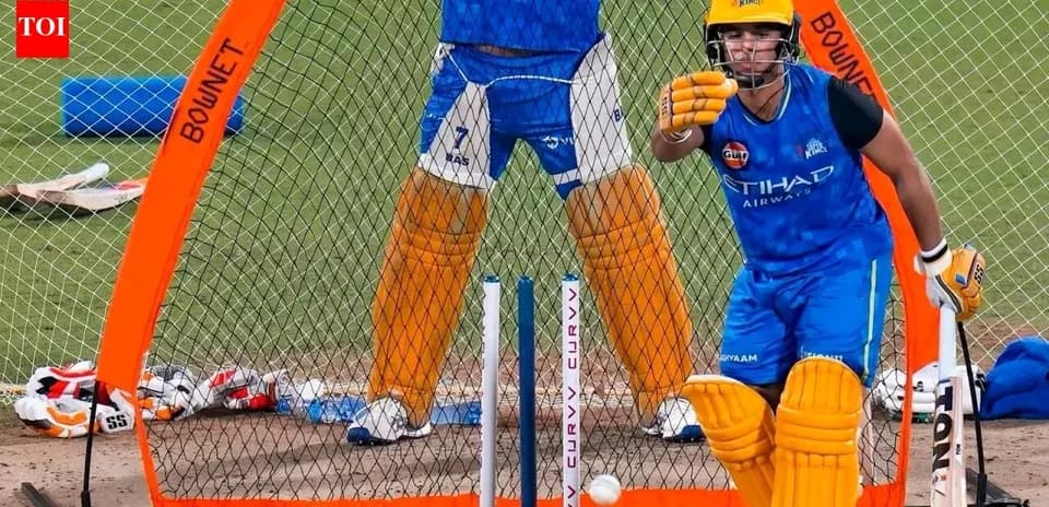 Batsman practicing in nets with wicketkeeper behind