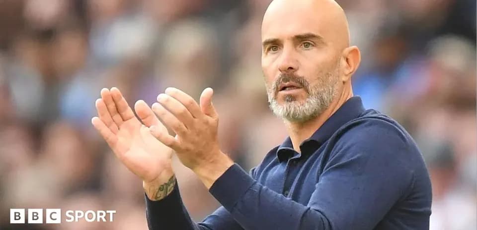 Coach applauding during a football match