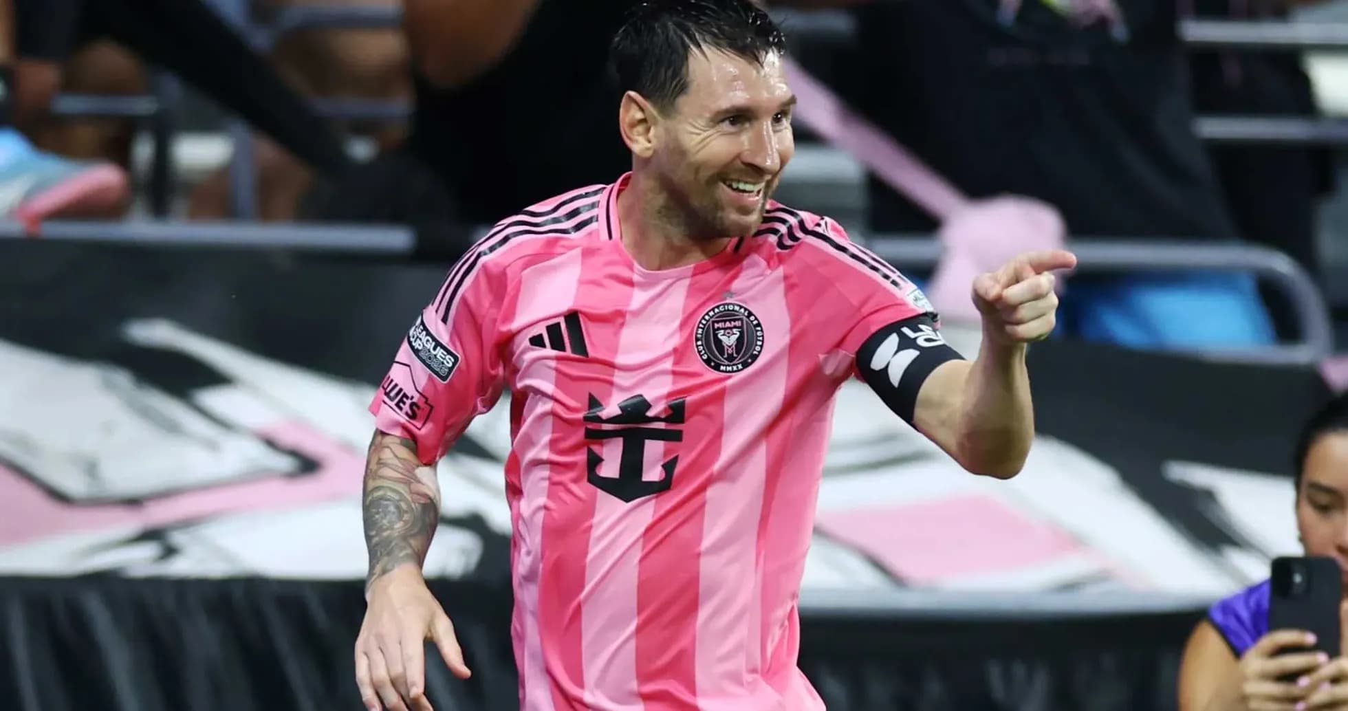 Player celebrating a goal in pink jersey