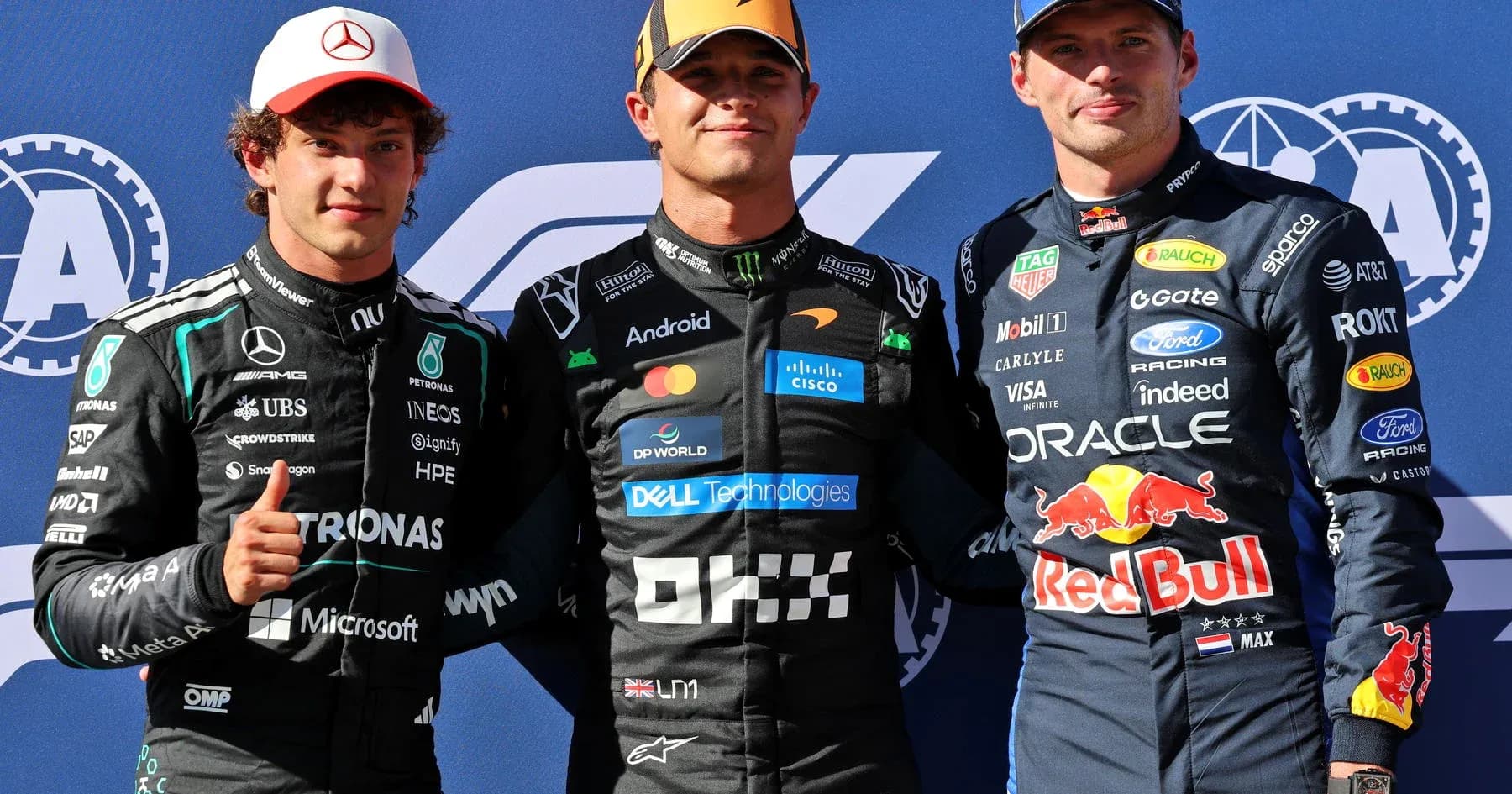 Three Formula 1 drivers posing for a photo