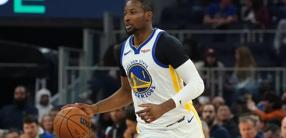 Player dribbling basketball during game for Warriors