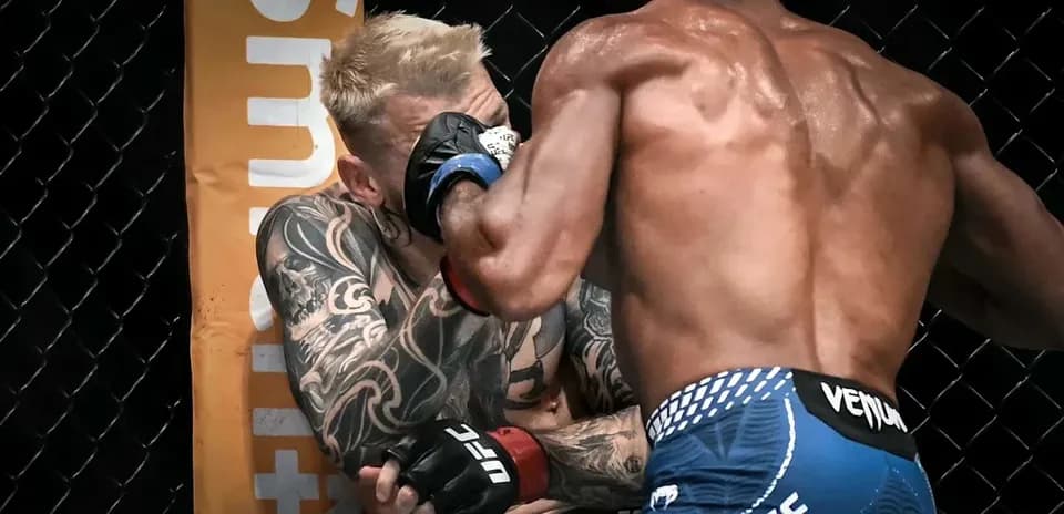 Two fighters exchanging blows in an MMA match