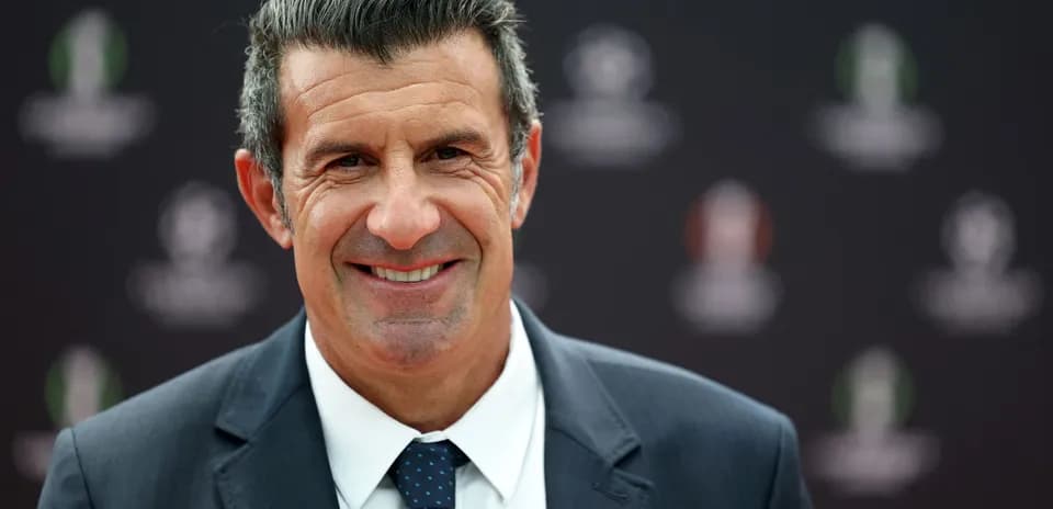 Man smiling in a formal suit at event