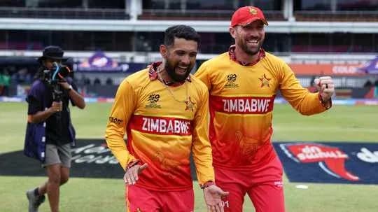 Two Zimbabwe players celebrating on the field