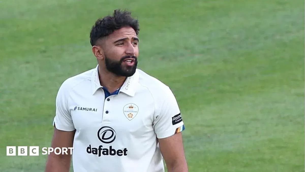 Cricketer wearing white kit on field during match