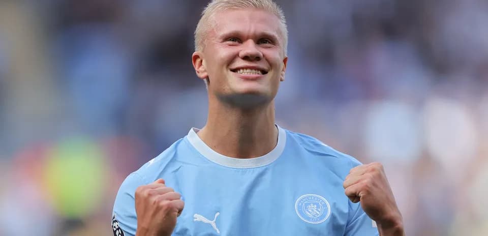 Player celebrating in Manchester City kit after match