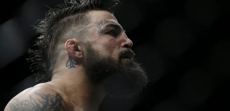 Close-up of fighter with tattoos in ring