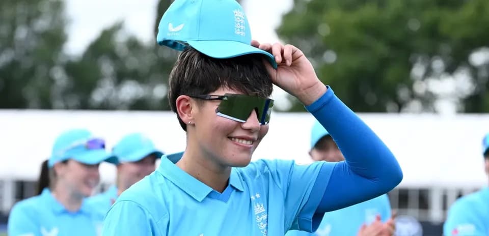 Player adjusting cap during team event celebration