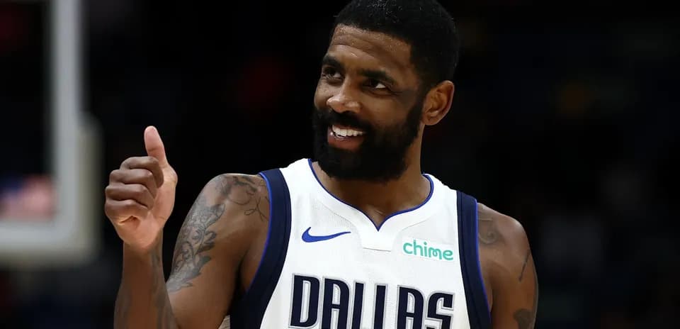 Player in Dallas Mavericks jersey giving thumbs up
