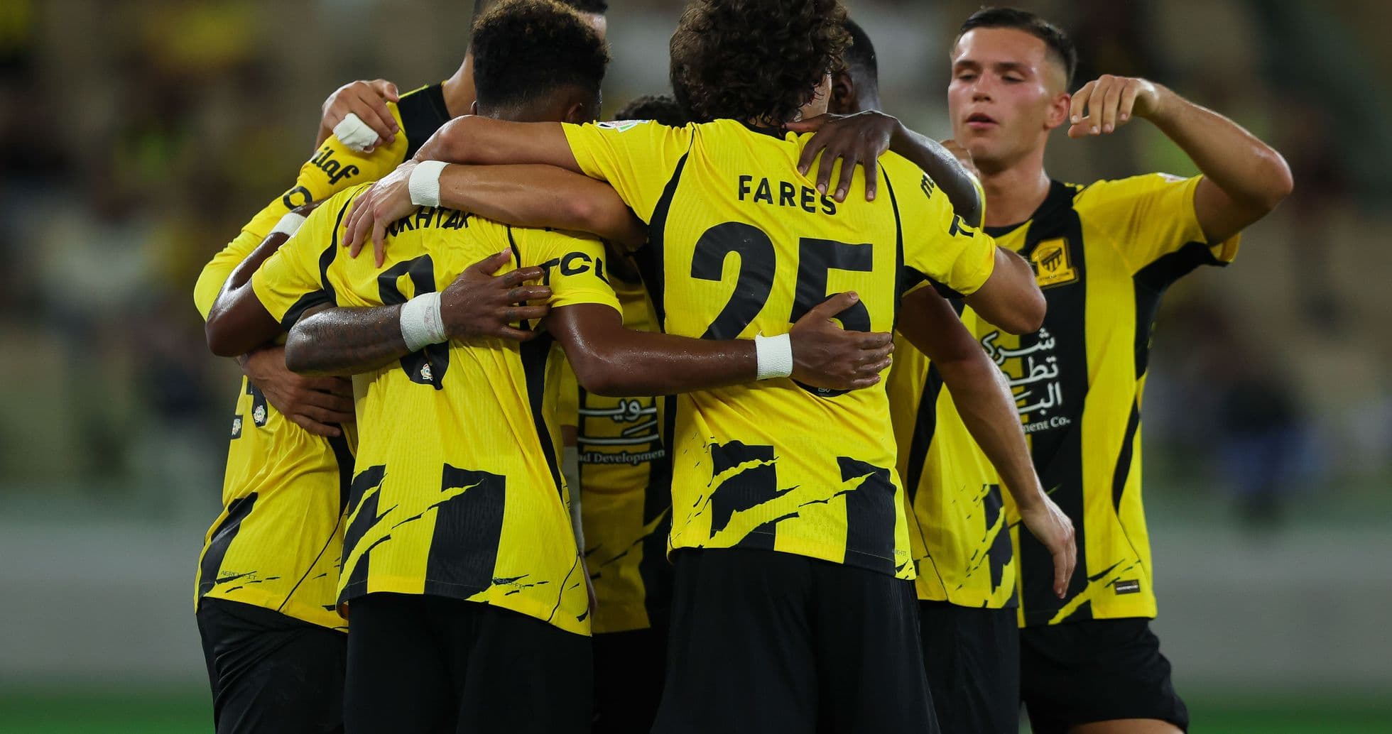 Players celebrating a goal in yellow jerseys