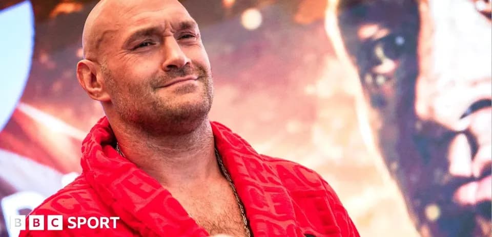 Boxer in red robe at promotional event