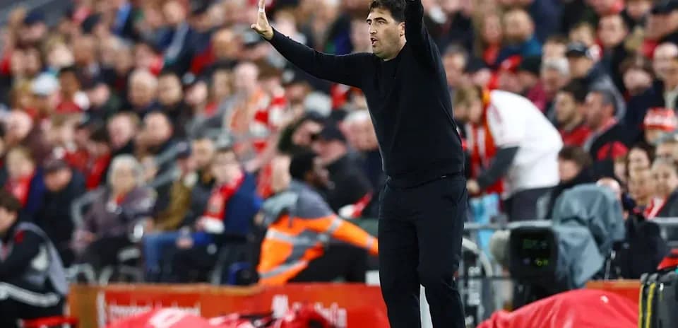 Coach giving instructions during a football match