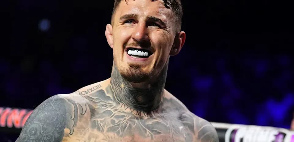 Boxer smiling with tattoos in ring