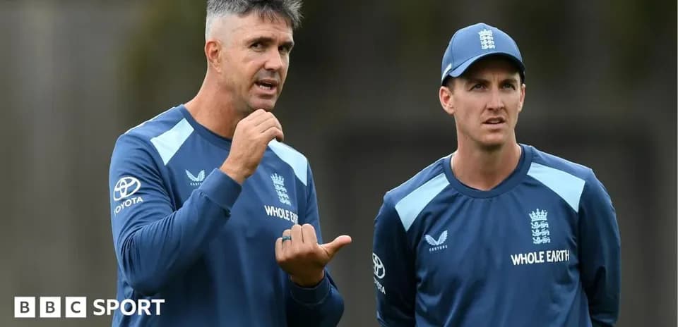 Two cricket coaches discussing during training session