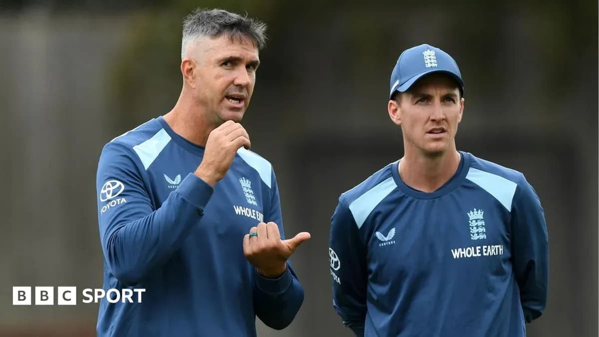 Two cricket coaches discussing during training session